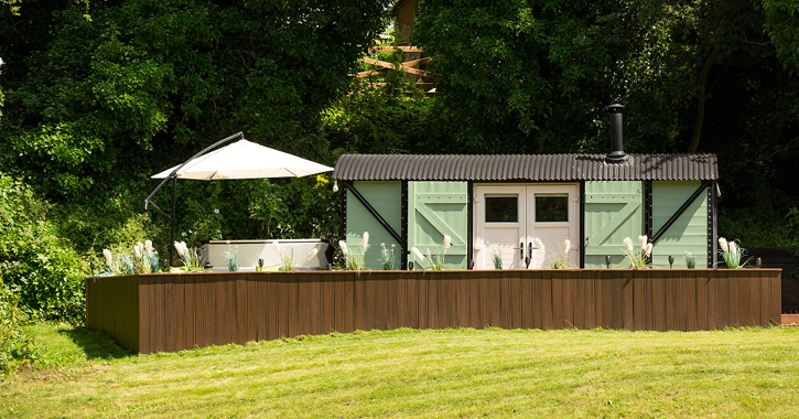 View of Beamish Glamping converted railway carriage and hotrub